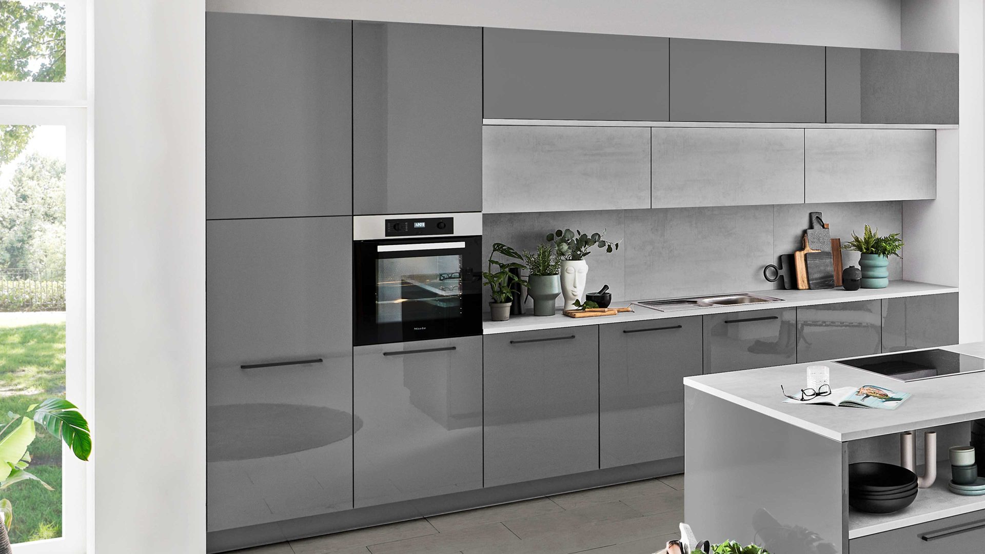 Einbauküche Nolte® küchen aus Holz in Grau nolte® Einbauküche Lux mit Miele Einbaugeräten Quarzgrau & weißer Beton – zweizeilig